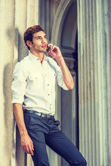 Wall Mural - Young American Businessman Calling outside in New York