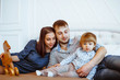 © venerala - parents with a child playing on bed with toys