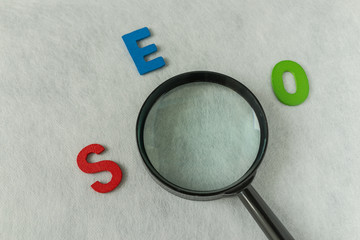 Aufkleber - search engine optimization concept as alphabet abbreviation seo and magnification glass