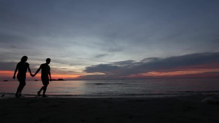 Wall Mural - beautiful couple on honeymoon at sunset beach, romantic background