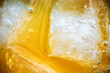 Close-up of ice cubes in orange juice