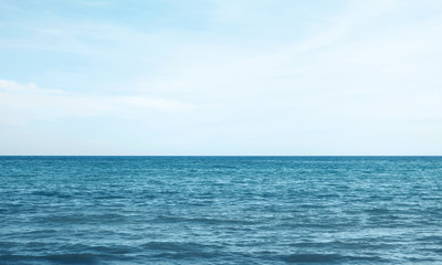 Vacation, travel and background concept - blue sea or ocean with sky