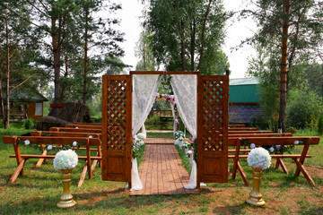 fragment like view of nice chairs and arch ready for wedding ceremony.