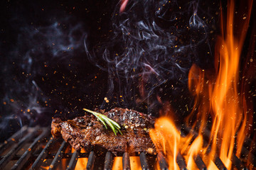 Poster - Beef steaks on the grill with flames