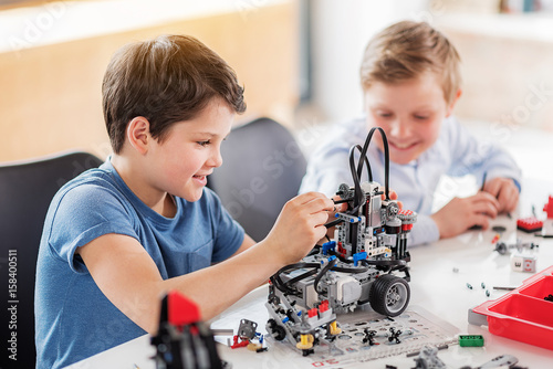 Happy smiling boys having fun in workshop Poster Mural XXL
