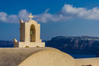 The cross that crowns the belfry of FIRA in Santorini - Greece