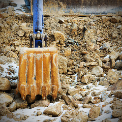 Bulldozer excavator loader machine works outdoors at construction site.