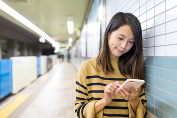 Sticker - Woman working on cellphone in train station