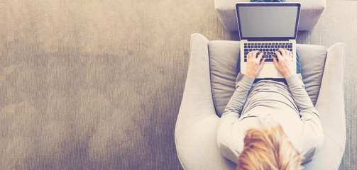 Wall Mural - Top down view of person typing on laptop