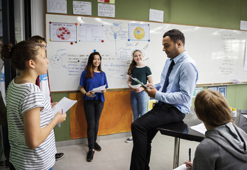 Wall Mural - group of students presentation in classroom