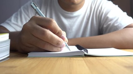 Poster - hand pen writes in a notebook