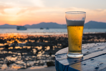 Glass of beer on a sunset