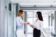 © Alvin Harambašić - Business womens doing handshake at modern company interior