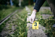 © Forance - Placing the crime scene marker on the ground near train track