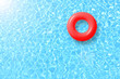 canvas print picture - red swimming pool ring float in blue water and sun bright. concept color summer.