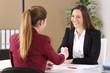 © Antonioguillem - Two businesswomen handshaking at office