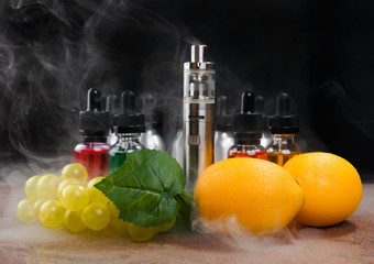 Wall Mural - Electronic cigarette, lemons and bunch of grapes within vapor on black background