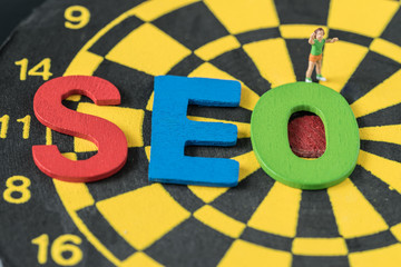Aufkleber - search engine optimization concept as colorful alphabet abbreviation seo on dartboard and miniature 