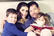 © fmarsicano - Happy family in bed relaxing smiling looking camera