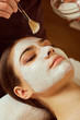 © Studio Romantic - On face of  woman beautician applies a mask in the spa salon.