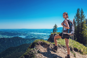 Wall Mural - female hiker admiring nature on mountain summit