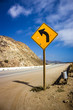 Yellow left turn sign along the winding Pacific Coast Highway, S