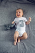 © saulich84 - newborn to three months lying on the bed with the number three and the hare toy