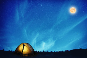 Wall Mural - illuminated camping tent at night