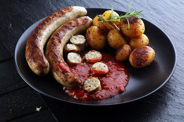 Wall Mural - grilled sausages and potatoes