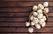 Top view of mushrooms champignon on wooden table. Copy space.