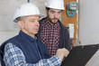 © auremar - builders with clipboard and electrical panel indoors