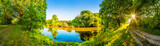 Fototapeta Panele - Landschaft im Sommer mit Fluss, Sonne, Weg und Wald