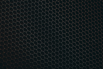 abstract texture honeycomb. Metallic net background or texture. metal mesh. full frame colourful illuminated detail of a metallic grid in front of a loudspeaker. Colorful abstract background.