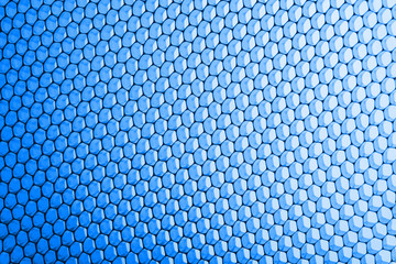 abstract texture honeycomb. Metallic net background or texture. metal mesh. full frame colourful illuminated detail of a metallic grid in front of a loudspeaker. Colorful abstract background.