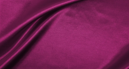 Smooth elegant pink silk or satin luxury cloth texture as abstract background. Luxurious background design