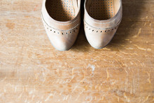 Beige Leather Shoes With Orthopedic Insoles. Wooden Background.