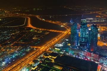 Wall Mural - Panoramic aerial view on downtown of Dubai with modern high skyscrapers at night. Architecture of future with bright lights and roads. Famous tourist destination