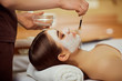 © Studio Romantic - Cosmetologist puts a mask from cream on girl's face in the spa salon.