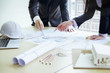 © successphoto - Image of engineer meeting for architectural project. working with partner and engineering tools on workplace