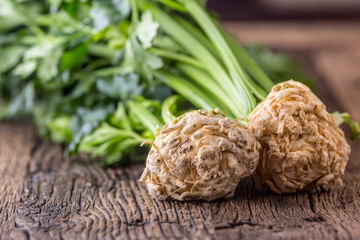 Wall Mural - Celery root. Fresh celery root with leaf on rustic oak table.