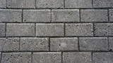 Fototapeta  - Gray brick stone road. Pavement texture photography.