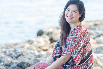 portrait of beautiful Asia woman wearing long dress on the beach and for people vacation in paradise destination