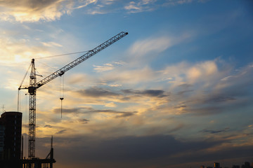 2 tower cranes on a blue sky background