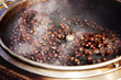 Roasted chestnuts in a hot pan, a step in roasting chestnut seeds with hot pebbles. selective focus.