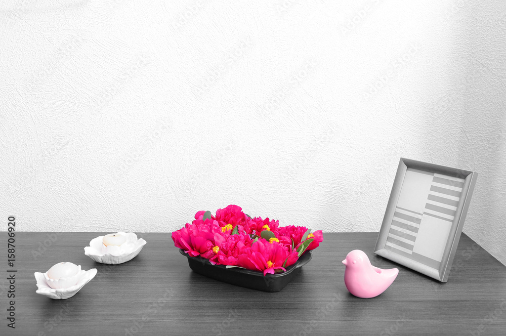 Beautiful composition with peony flowers and candles on table