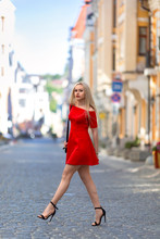 Woman In The Red Dress Walking Outdoor.