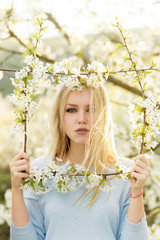 Wall Mural - girl holding frame of white, blossoming flowers