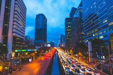 Wall Mural - traffic in the city at night with high building.