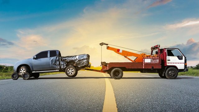 Fototapete - Tow truck delivers the damaged vehicle, Sun light flare, Selective focus