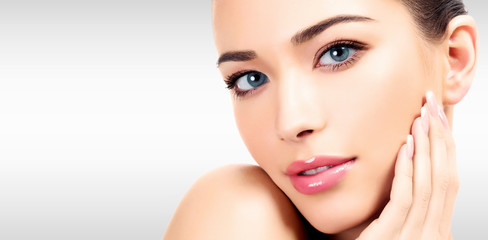closeup headshot portrait of a beautiful woman with beauty face and clean smooth soft skin , mild ma